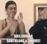 a woman clapping with the words bbs shukla save klang and shuvee