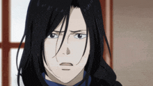 a close up of a person with long black hair making a face