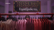 a woman stands in front of a rack of clothes with the word cklass on the bottom right