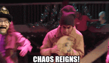 a group of people are dancing with the words chaos reigns in the corner