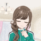 a girl with brown hair is wearing a green jacket with the letter w on it