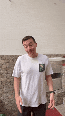 a man wearing a white shirt that says miami surf club on it