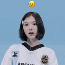 a girl wearing a white archivo shirt looks down at something