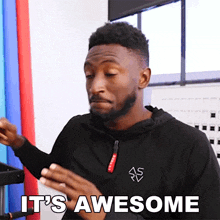 a man says it 's awesome while holding a cell phone