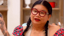a woman with braids and glasses is on the great canadian baking show .