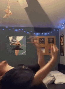a person laying on a bed with a picture of a ballerina on the wall