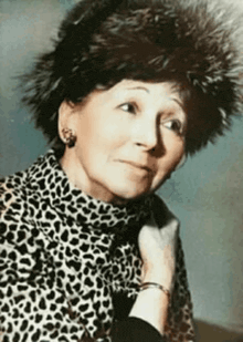 an older woman wearing a fur hat and a leopard print shirt