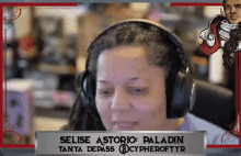 a woman wearing headphones with a name plate that says selise asterio paladin tanya depass @cypheroftyr