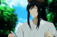 a man with long black hair wearing a white shirt