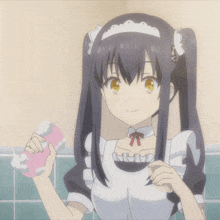 a girl in a maid outfit is holding something in her hand