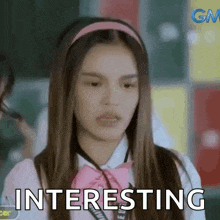 a girl in a school uniform is making a funny face and says `` interesting '' .
