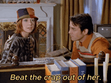 a man and a woman are sitting in front of a fireplace with the words beat the crap out of her below them