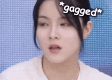 a close up of a woman 's face with the words `` gagged '' written above her head .
