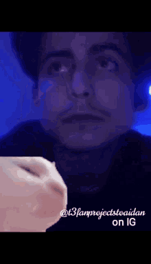 a close up of a man 's face with a cat 's face in the foreground .