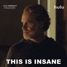 a poster for nine perfect strangers shows a man with a beard saying this is insane