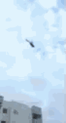 a person is flying through a cloudy sky in a blurry photo .