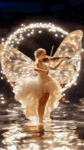 a woman in a white dress with wings is playing a violin .