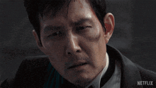 a close up of a man 's face with the word netflix on the bottom right