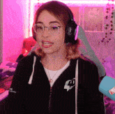 a woman wearing headphones and a black jacket with the number 40 on the sleeve