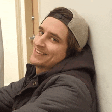 a man wearing a hat that says ' abercrombie & fitch ' on it smiles