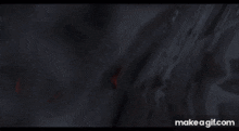a person is standing in a dark room with smoke coming out of the ceiling .