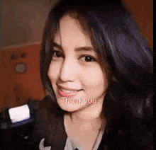 a close up of a woman 's face with the words thank you written on it