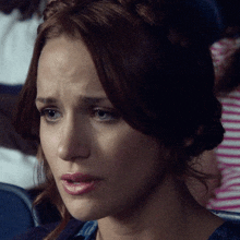 a close up of a woman 's face with her eyes closed