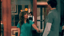 a man and a woman holding hands in front of a restaurant