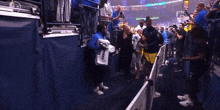 a woman carrying a bag that says gatorade in front of a crowd