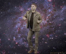 a man in a jacket is dancing in front of a galaxy of stars .