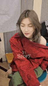 a woman wearing a red jacket that says story on the sleeves