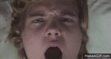 a close up of a person yawning with their mouth open