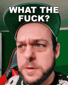 a man with a beard wearing a hat that says what the fuck on it
