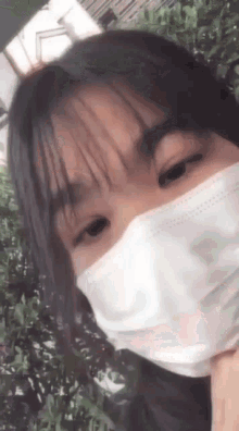 a close up of a girl wearing a face mask