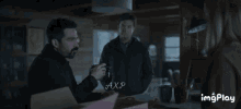 a group of people standing around a table with axp written on the bottom of the screen