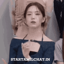 a woman in a blue off the shoulder top with the words starttamilchat.in above her