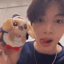a young man is holding a stuffed animal in his hand .