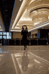 a man in a pharaoh mask is walking in a lobby
