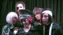 a group of people are posing for a picture together .