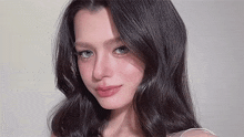 a close up of a woman 's face with long black hair