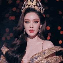 a woman wearing a crown and a dress that says miss grand thailand