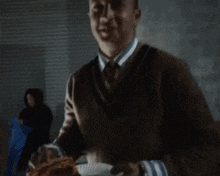 a man wearing a sweater and tie is asking some za