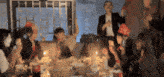 a group of people are gathered around a table with a bottle of coca cola