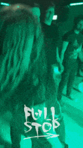 a poster for full stop shows a woman dancing in a dark room