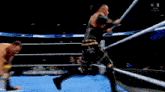 two men are wrestling in a ring and one of them is wearing a belt that says wwe on it .