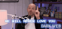a man in front of a microphone with the words " we will never love you dark web "