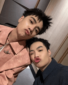two young men are making funny faces with their mouths open