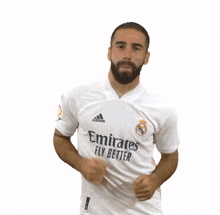 a man with a beard wearing a white shirt that says fly better