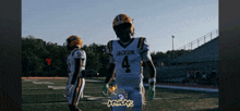 a football player wearing a jackson jersey walks on the field