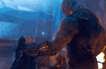 a man wearing a glove that says infinity gauntlet